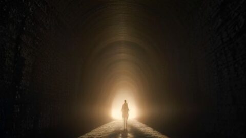 A Lone Soul Walks Toward the Light at Tunnel’s End